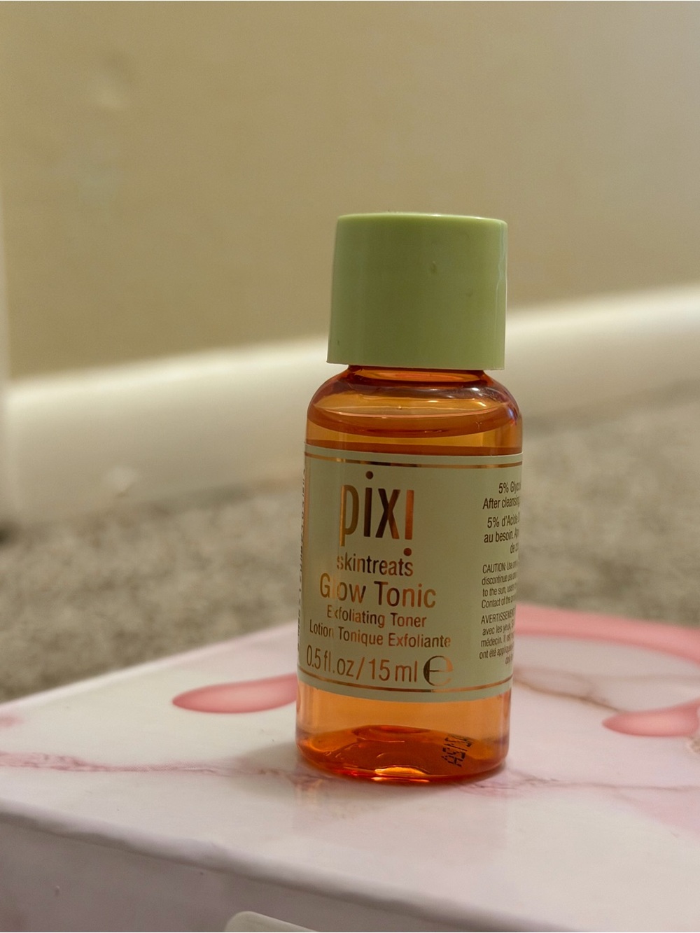 Pixi Glow Tonic Mini Bottle with Light Green Cap and Amber Liquid